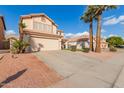 Two-story house with a tan exterior, two-car garage, and landscaped front yard at 4248 E Raven Rd, Phoenix, AZ 85044