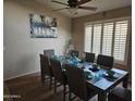 Dining area with wooden table, six chairs and modern decoration at 43726 W Carey Dr, Maricopa, AZ 85138