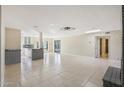 Open living space with tile floors and a view of the kitchen at 5013 W Orchid Ln, Glendale, AZ 85302