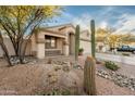 Inviting single-story home with desert landscaping, cacti, and a cozy front porch at 505 W Wayland Dr, Phoenix, AZ 85041