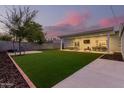 Expansive backyard with grassy lawn, patio, and privacy wall at 533 W Oregon Ave, Phoenix, AZ 85013