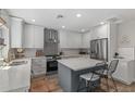 Modern kitchen featuring white cabinets, quartz countertops, and a large island at 533 W Oregon Ave, Phoenix, AZ 85013