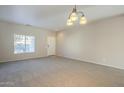 Bright and spacious living room with neutral carpeting at 5427 W St Kateri Dr, Laveen, AZ 85339