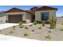 One-story home with brown garage door and desert landscaping at 5509 N 193Rd Ave, Litchfield Park, AZ 85340