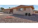 Brick home showcasing a side view with well-maintained landscaping at 6457 E Dallas St, Mesa, AZ 85205