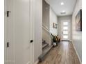 Bright entryway with wood-look tile floors and modern staircase at 7460 E Via De Luna Dr, Scottsdale, AZ 85255