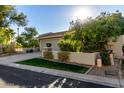 House exterior with a large tree and driveway at 8100 E Camelback Rd # 14, Scottsdale, AZ 85251