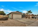 Well-maintained house with light green exterior and a two-car garage at 8533 E Monte Ave, Mesa, AZ 85209