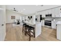 Modern kitchen with white cabinets, quartz countertops, and island at 8533 E Monte Ave, Mesa, AZ 85209