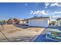 House exterior with a spacious driveway and two-car garage at 8641 E Fillmore St, Scottsdale, AZ 85257