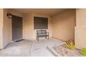 Front entry with a bench, door, and small planter at 9030 S Maple Ave, Tempe, AZ 85284