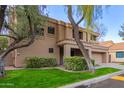 Two-story house with a tan exterior, two-car garage, and landscaped front yard at 9030 S Maple Ave, Tempe, AZ 85284