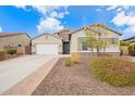 Single-story home with neutral exterior, two-car garage, and landscaped yard at 9364 W Cashman Dr, Peoria, AZ 85383