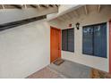 Condo entry with orange door and small patio at 9990 N Scottsdale Rd # 1048, Paradise Valley, AZ 85253