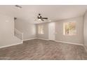 Spacious living room with wood-look floors and ceiling fan at 106 N 66Th Ave, Phoenix, AZ 85043