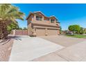 Two-story house with a three-car garage and gated driveway at 1116 W Courtney Ln, Tempe, AZ 85284