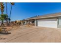 Wide driveway leading to a well-kept single-story home with a porch, offering ample parking at 134 N 87Th St, Mesa, AZ 85207