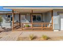 Inviting front porch with wood railings, offering a cozy spot to relax and enjoy the outdoors at 134 N 87Th St, Mesa, AZ 85207