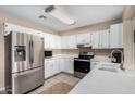 Well-lit kitchen with stainless steel appliances, white cabinetry, and ample counter space at 134 N 87Th St, Mesa, AZ 85207