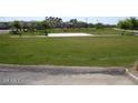 Community park with grassy area and a sand volleyball court at 14970 W Riviera Dr, Surprise, AZ 85379