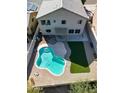 Aerial view of a kidney shaped pool with artificial turf at 15058 W Fillmore St, Goodyear, AZ 85338