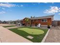 Ranch-style home with putting green and updated landscaping at 1561 W 5Th St, Mesa, AZ 85201