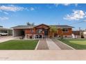 Charming brick home with a landscaped front yard and putting green at 1561 W 5Th St, Mesa, AZ 85201