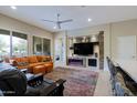 Living room features a fireplace, large TV, and comfortable seating at 16918 W Palm Ln, Goodyear, AZ 85395