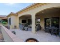 Covered patio with seating area, fire pit, and outdoor TV at 16918 W Palm Ln, Goodyear, AZ 85395