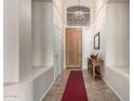 Bright foyer with high ceilings, tiled floors, and a wooden front door at 18001 N 53Rd St, Scottsdale, AZ 85254