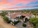 Luxury estate home with a tile roof, multiple wings, and a large backyard at 30508 N 64Th St, Cave Creek, AZ 85331