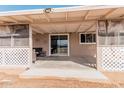 Covered patio with seating area, adjacent to the house at 3315 N Datura Ct, Maricopa, AZ 85139