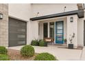 Welcoming front entry with a blue door, potted plants and a cozy bench at 3891 W Talc Dr, San Tan Valley, AZ 85144