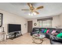 Living room with sectional sofa and ceiling fan at 4219 W Pasadena Ave, Phoenix, AZ 85019