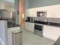 Modern kitchen with stainless steel appliances and white cabinets at 4330 E South Fork Dr, Phoenix, AZ 85044