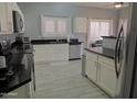 Spacious kitchen with white cabinets, stainless steel appliances, and tile floors at 4330 E South Fork Dr, Phoenix, AZ 85044