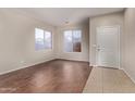 Living room with tile floors and large windows at 44230 W Palmen Dr, Maricopa, AZ 85138