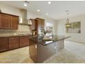 Spacious kitchen featuring stainless steel appliances and granite island at 4937 S Pulse Ter, Mesa, AZ 85212