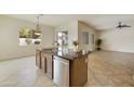 Island kitchen with dark wood cabinets and granite countertops at 4937 S Pulse Ter, Mesa, AZ 85212
