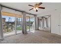 Bright bedroom with mirrored closet and access to patio at 6501 N 17Th Ave # 112, Phoenix, AZ 85015