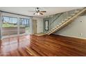 Living room features hardwood floors and open staircase at 6501 N 17Th Ave # 112, Phoenix, AZ 85015