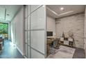 Bright home office with a built-in desk and sliding glass partition at 6803 E Main St # 1110, Scottsdale, AZ 85251