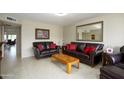 Spacious living room features comfortable leather sofas and a large mirror at 7755 E Laguna Azul Ave # 147, Mesa, AZ 85209