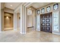 Spacious entryway with tile floors, high ceilings, and a built-in bench at 8037 E Thorntree Dr, Scottsdale, AZ 85266
