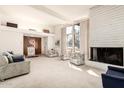 Spacious living room with fireplace and large windows at 8208 E Shea Blvd, Scottsdale, AZ 85260