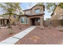 Two-story house with a front porch and walkway at 9331 S 33Rd Gln, Laveen, AZ 85339