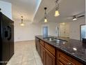 Bright kitchen features granite counters, wood cabinets, stainless steel appliances and pendant lighting at 10136 E Southern Ave # 1110, Mesa, AZ 85209