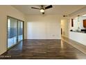 Living room with wood-look flooring, ceiling fan and glass doors to the outside patio at 10136 E Southern Ave # 1110, Mesa, AZ 85209