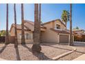 Two-story house with three-car garage and palm trees at 10359 W Sunflower Pl, Avondale, AZ 85392