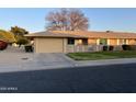 Front view of a single-story home with a garage and landscaping at 10604 W Camelot Cir, Sun City, AZ 85351